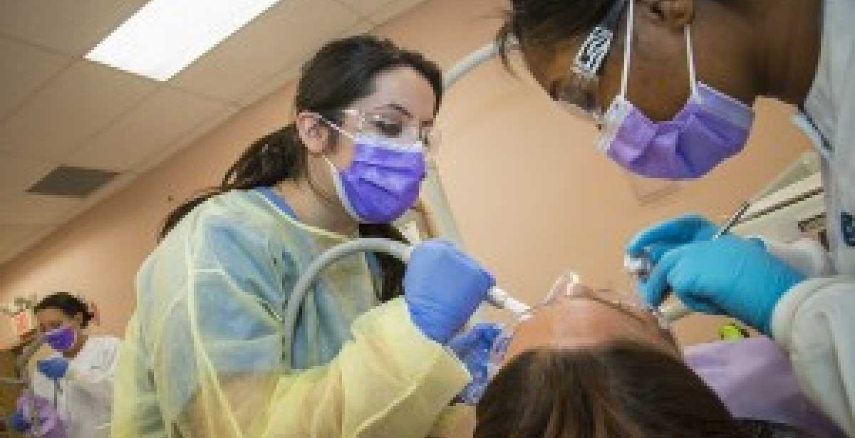 dental assistant with patient